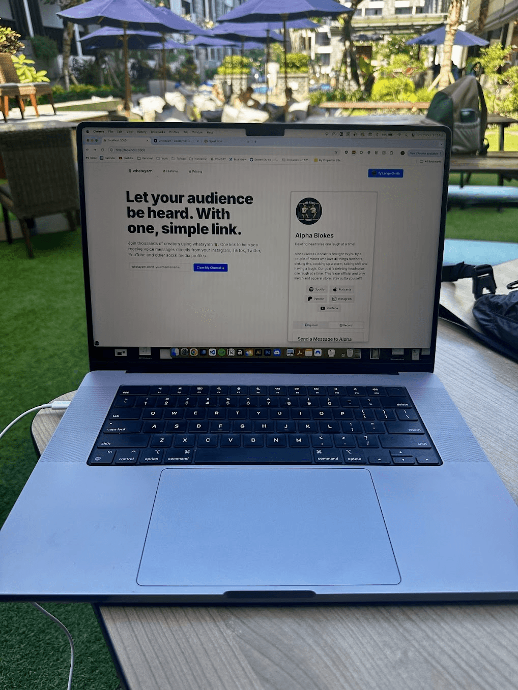 An early whatayarn homepage open on a laptop beside a pool in Bali