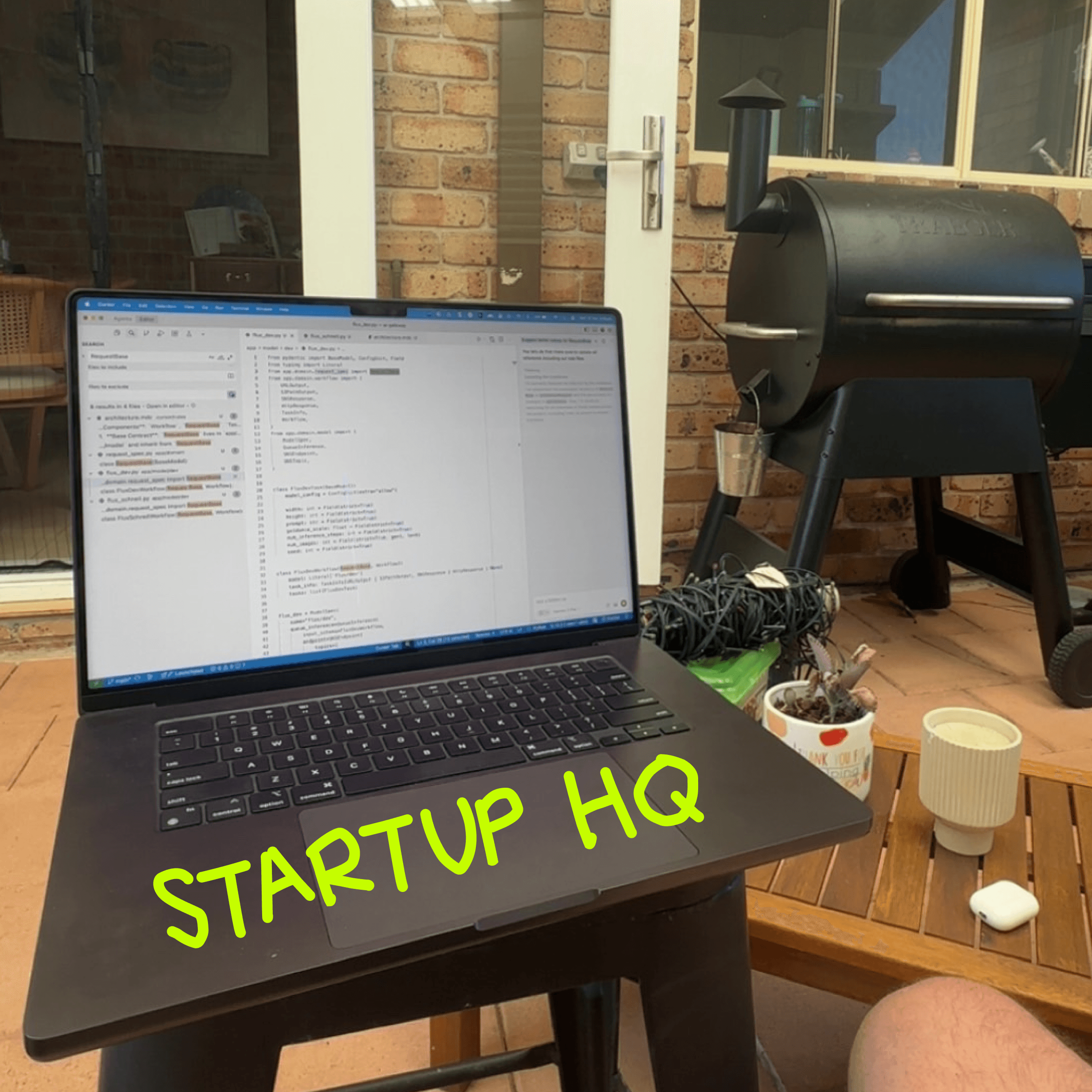 Ty’s laptop open on an outdoor table beside a barbecue, with Startup HQ written across the photo